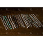 Set of beaded half bracelet on a wooden surface