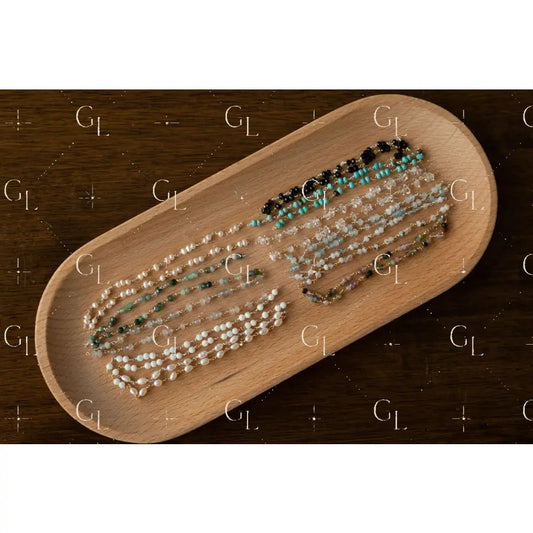 Wooden tray with bracelets on a dark wooden surface