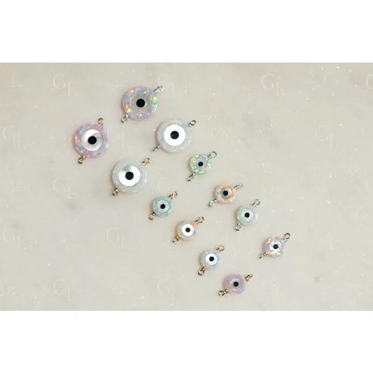 Evil eye charms on a light beige background