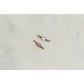Two gold and pink beaded connectors on a light gray background