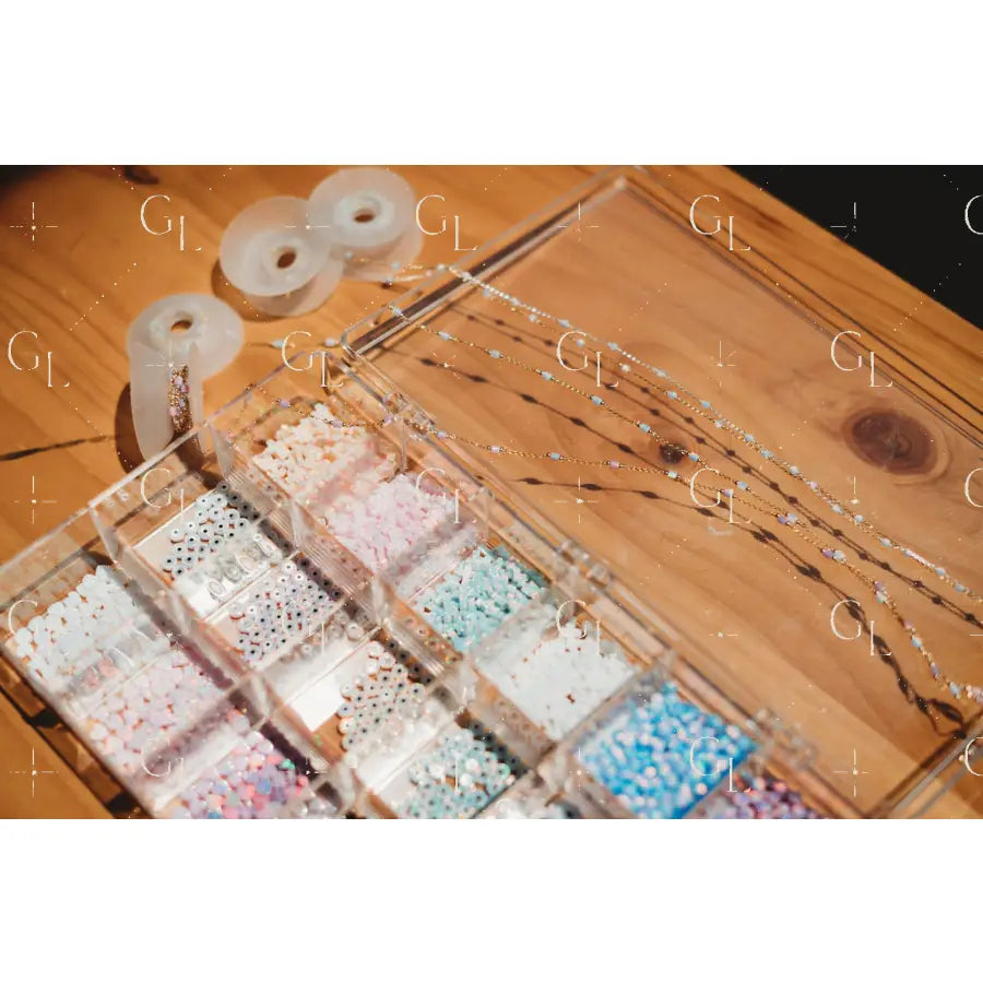 Jewelry display with beaded necklaces and a wooden box on a wooden surface