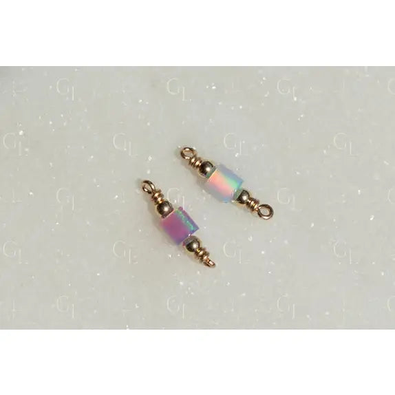 Two beaded charms with iridescent beads on a light gray background opal tube connectors!