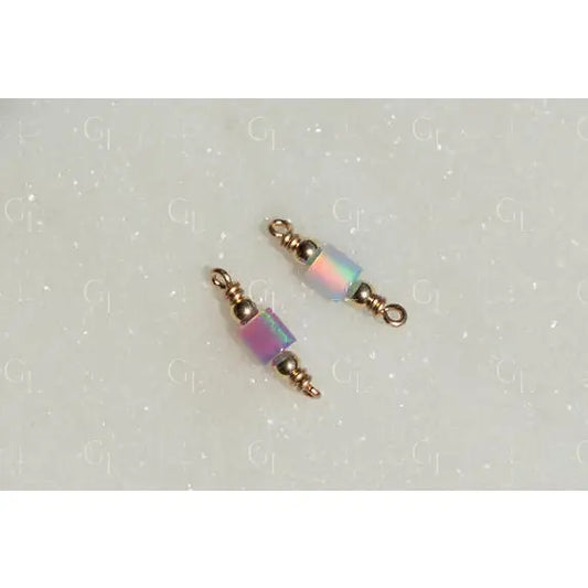 Two beaded charms with iridescent beads on a light gray background opal tube connectors!
