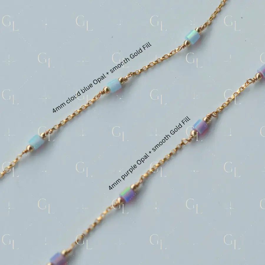 Gold chain necklace with cloud blue and purple opal beads on a light gray background