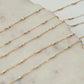 Gold chain necklaces on a marble surface