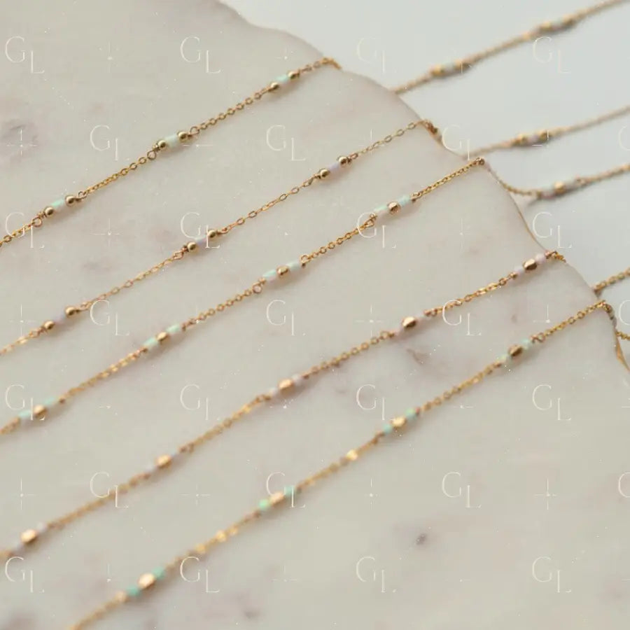 Gold chain necklaces on a marble surface