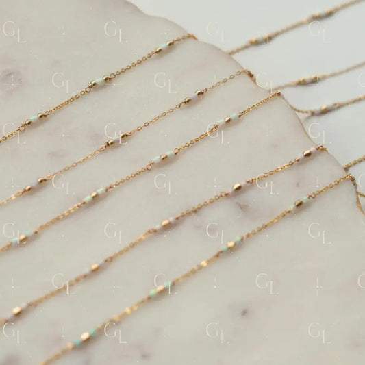 Gold chain necklaces on a marble surface