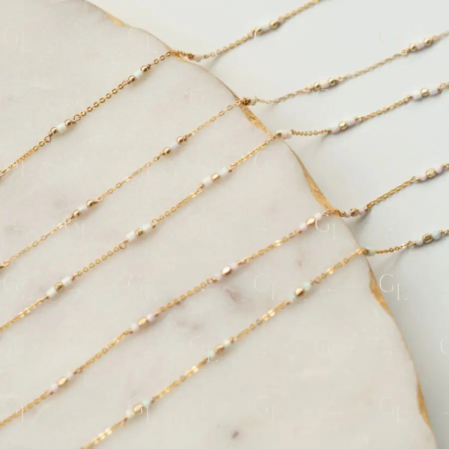 Gold fill chain necklace on a marble surface