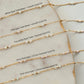 Gold fill necklaces with opal beads on a marble surface