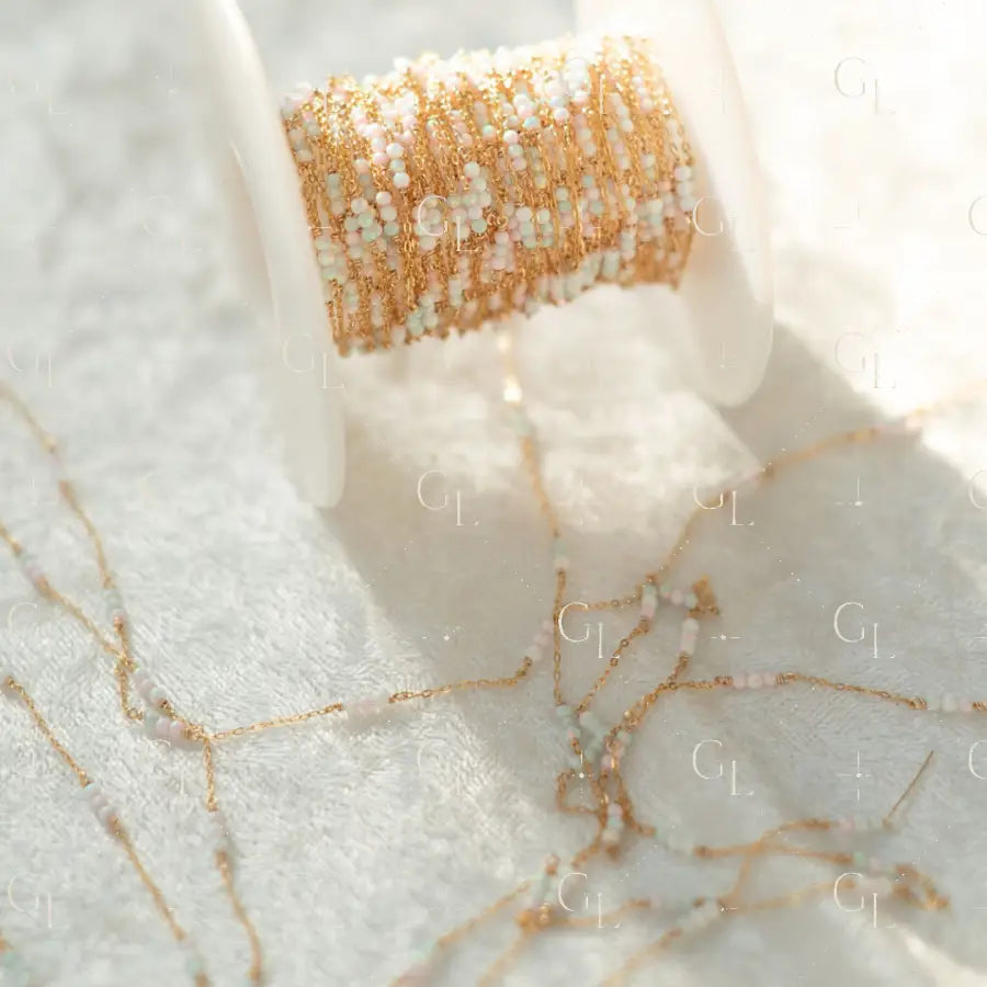 Close-up of a spool of gold thread on a marble surface