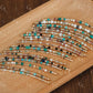Multiple beaded necklaces on a wooden surface