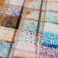 Assorted beads in a clear container on a wooden surface opal connectors 