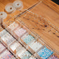 Jewelry display with beaded necklaces and a wooden box on a wooden surface