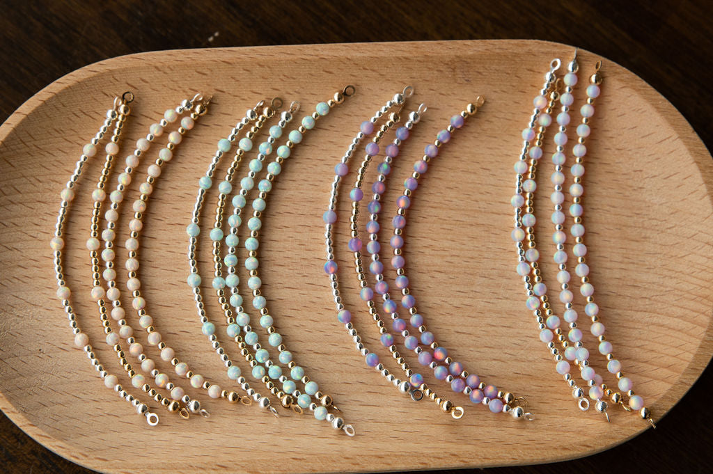 Set of beaded glow up half bead on a wooden surface