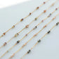 Gold chain necklaces with small beads on a light gray background