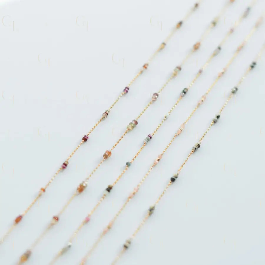 Set of thin beaded necklaces on a light background