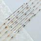 Jewelry strands with beads labeled on a white background