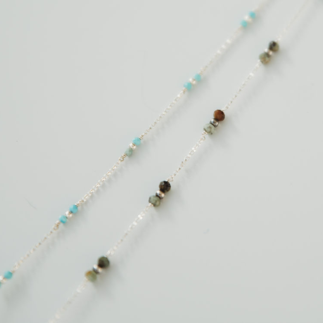 Necklace with multicolored beads on a light gray background