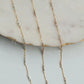 Gold fill necklace with small beads on a marble surface