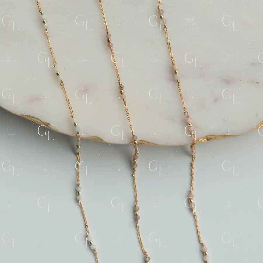 Gold fill necklace with small beads on a marble surface