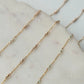 Gold chain necklace on a marble surface