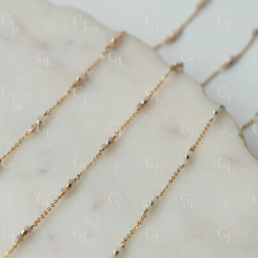 Gold chain necklace on a marble surface