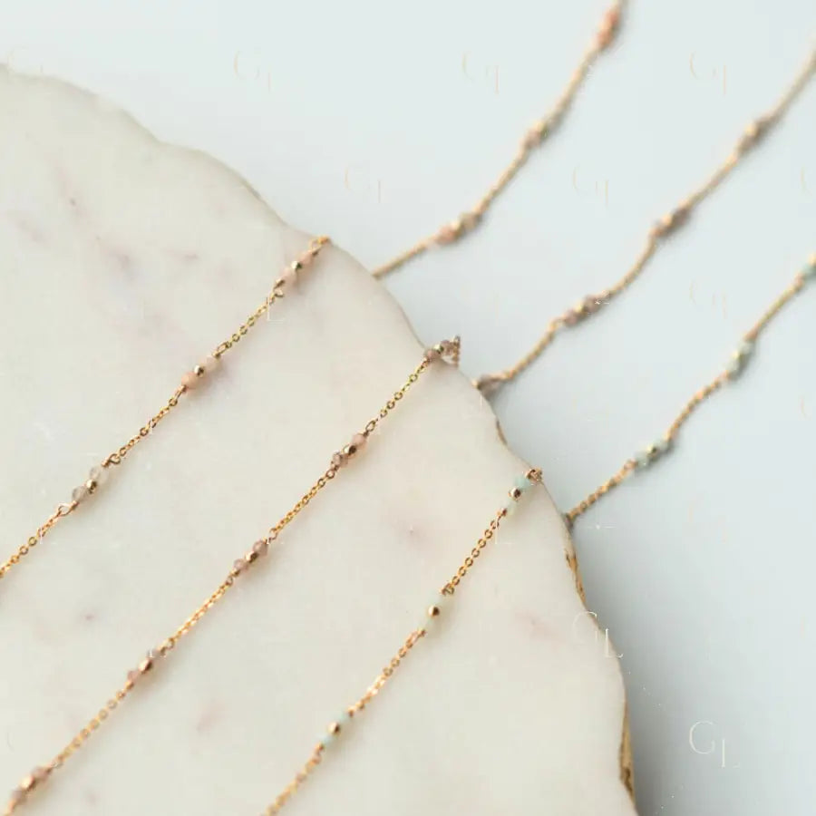 Gold fill chain necklaces on a marble surface