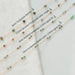 Four gold fill necklaces with turquoise beads on a light gray background