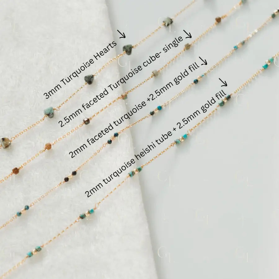 Four gold fill necklaces with turquoise beads on a light gray background