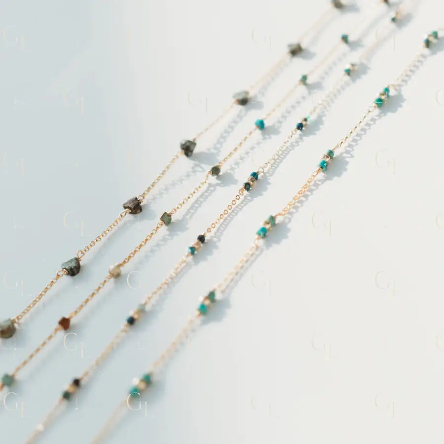 Multiple beaded necklaces on a light gray background