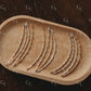 Set of gold and silver beaded bracelet on a wooden tray